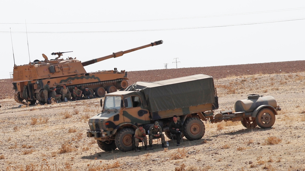 Turkish army vehicles and military personnel are stationed near the Turkish-Syrian border in Sanliurfa province, Turkey, October 12, 2019