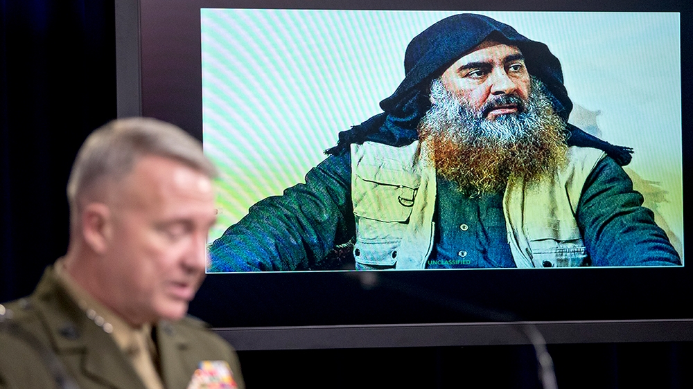 Abu Bakr al-Baghdadi is displayed on a monitor as U.S. Central Command Commander Marine Gen. Kenneth McKenzie at a joint press briefing at the Pentagon in Washington, Wednesday, Oct. 30, 2019, on the