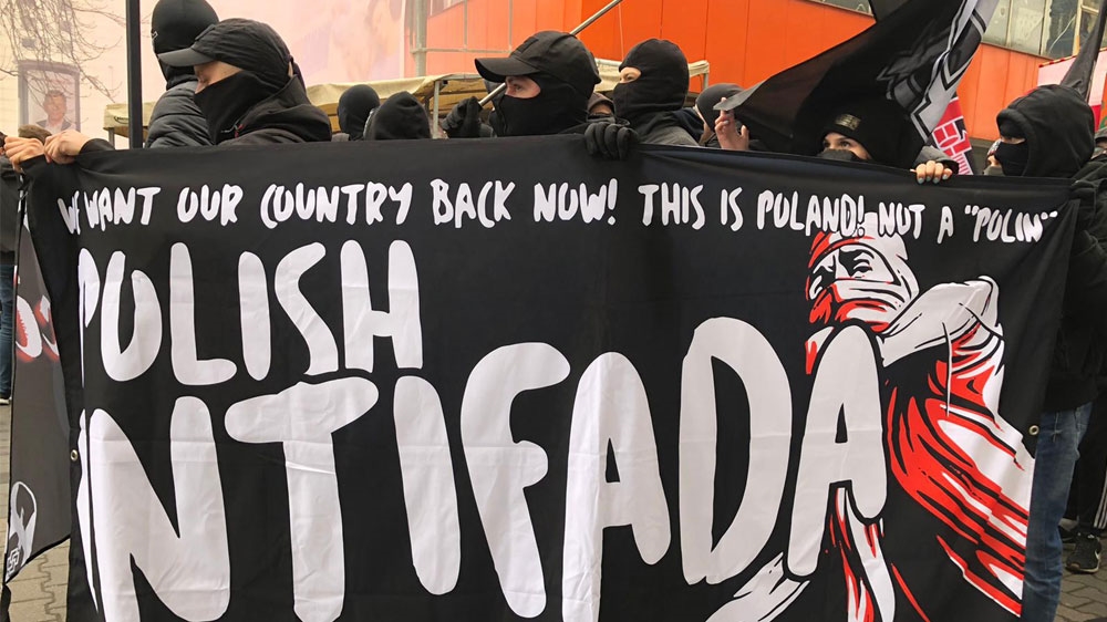 A poster reading ‘Polish Intifada’ refers to an anti-restitution bill