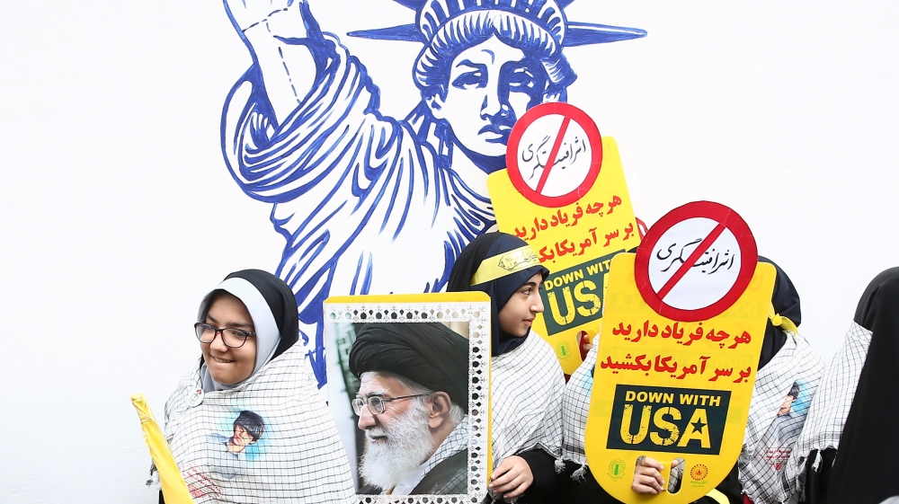 An Iranian protester holds the picture of Iranian Supreme Leader Ayatollah Ali Khamenei as they attend an anti U.S. demonstration