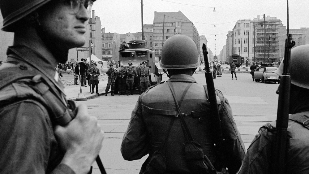 West Berlin, 1961: At Checkpoint Charlie, American soldiers watch as East Germany begins to put up the wall