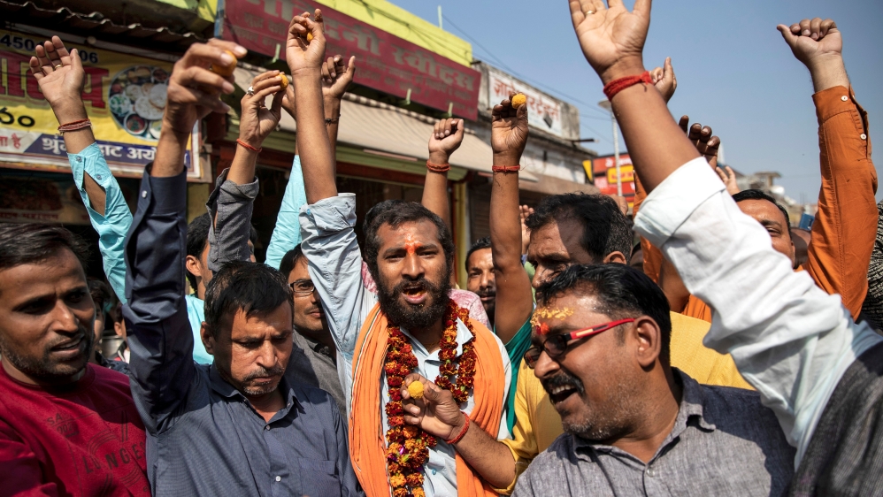Hindu devotees celebrate after Supreme Court''s verdict on a disputed religious site, in Ayodhya