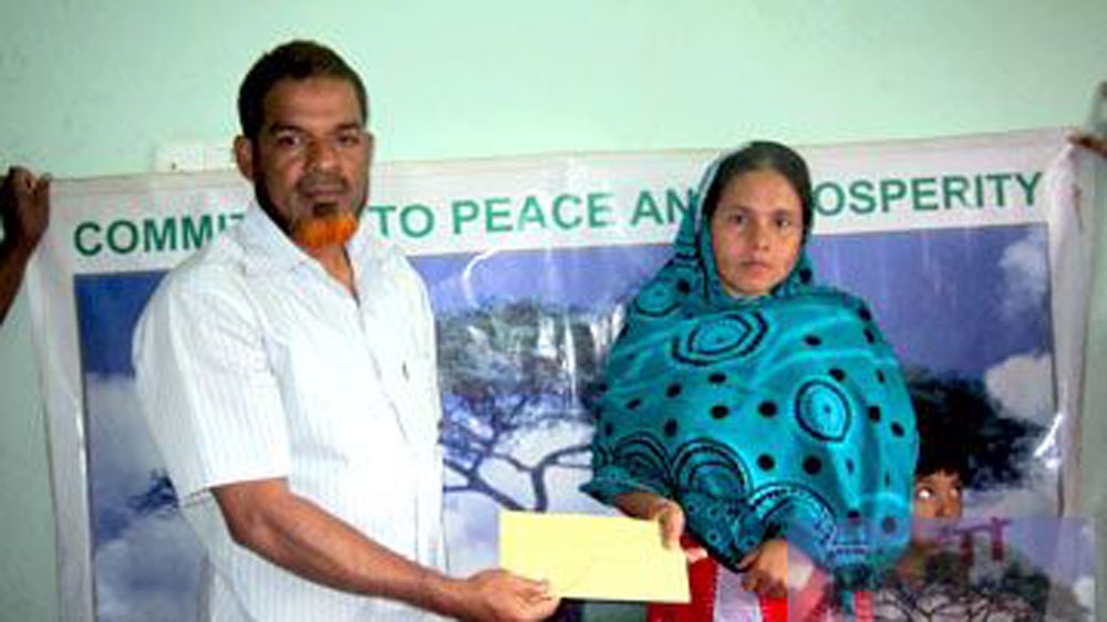 khandaker on left giving on charity