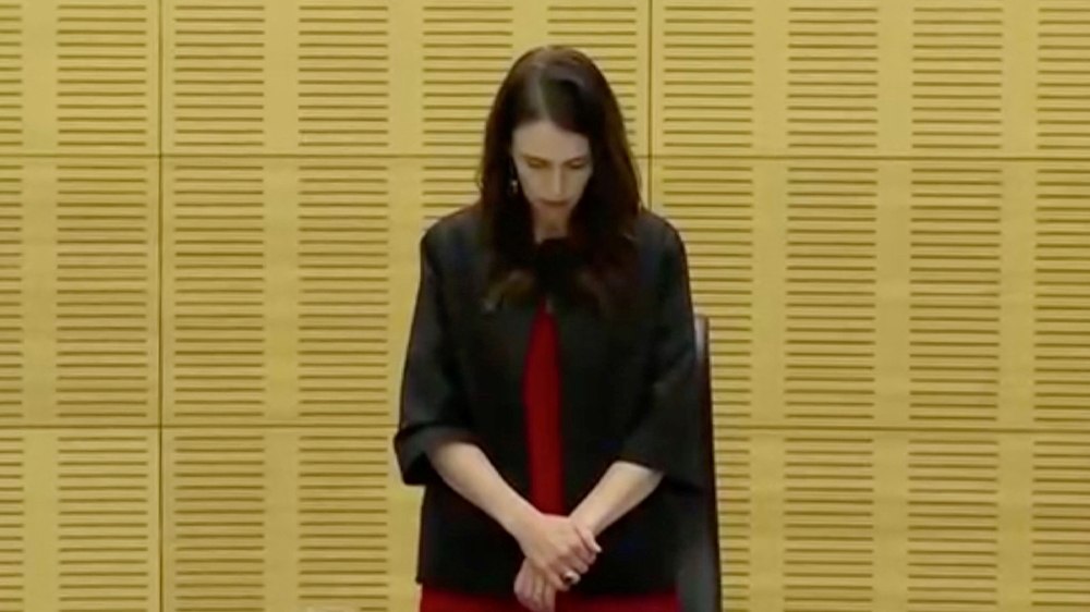 New Zealand’s Prime Minister Jacinda Ardern observes a minute of silence to mark one week since the eruption of White Island [TVNZ via Reuters]