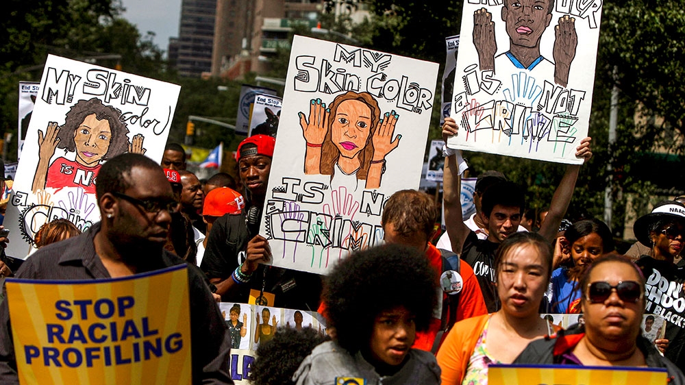 Protesters hold signs during a silent march to end the ‘stop-and-frisk’ programme in New York City