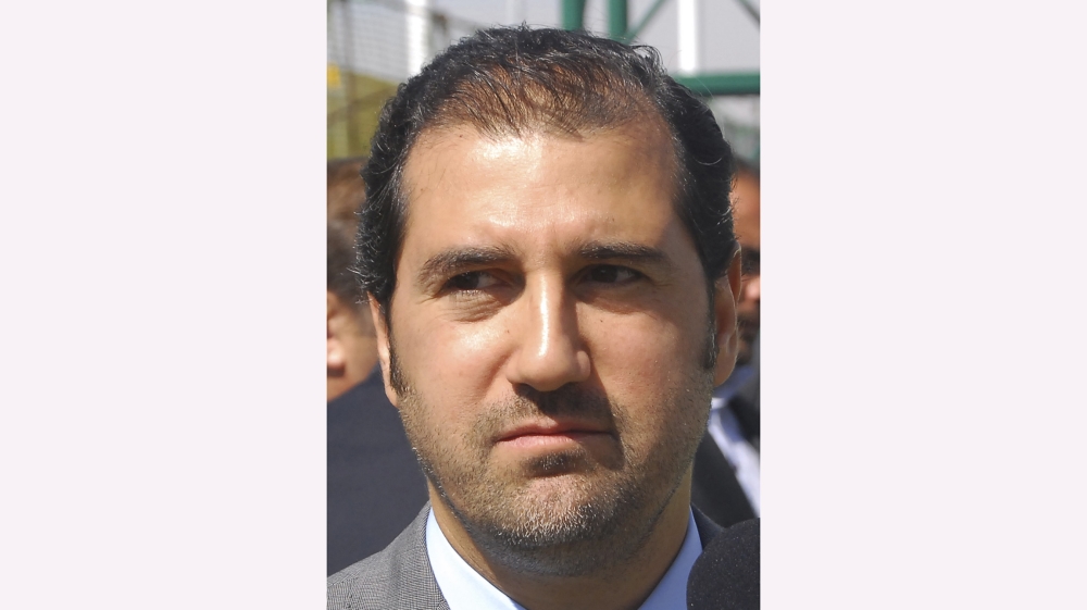 In this picture taken on April 24, 2010, Syrian President Bashar Assad''s cousin Rami Makhlouf, Syria''s most influential businessman, looks on during the laying the foundation stone of a hotel project,