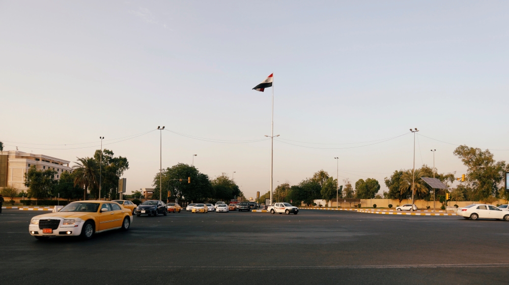Cars drive past the Green Zone of Baghdad