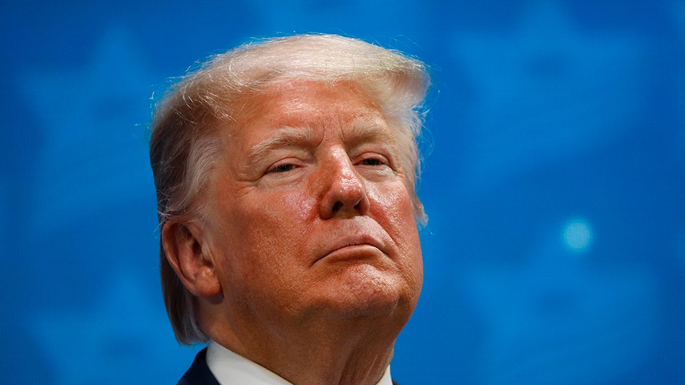 President Donald Trump stands onstage before speaking at the Israeli American Council National Summit in Hollywood, Fla., Saturday, Dec. 7, 2019. (AP Photo/Patrick Semansky)