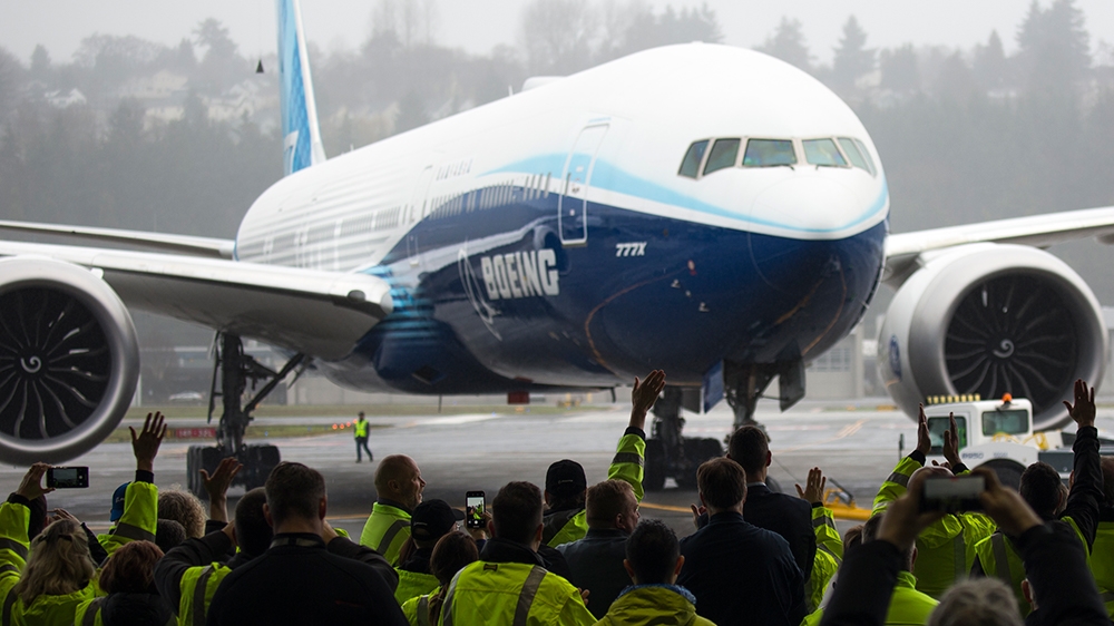 Boeing employees and guests welcome a Boeing 777X airplane returning from its inaugural flight at Boeing Field in Seattle, Washington on January 25, 2020. - Boeing's new long-haul 777X airliner made i