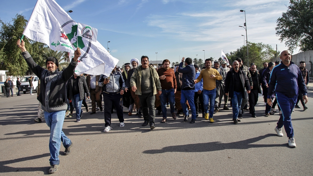 Pro-Iranian militiamen and their supporters chant slogans against the U.S. as they arrive in front of the U.S. embassy in Baghdad, Iraq, Wednesday, Jan. 1, 2020. U.S. troops fired tear gas on Wednesda