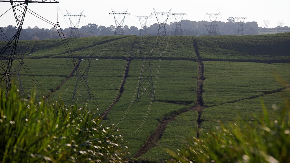 Power lines supplying electricity by state-owned Eskom run through sugar cane fields on a Tongaat Hulett farm in Shongweni, South Africa