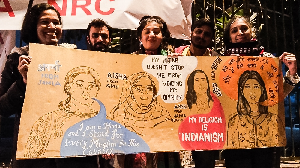 From left to right, artists Vidyun, Akshay, Gargi, Lokesh and Shefalee with their artwork outside Jamia Millia Islamia University campus in New Delhi [Courtesy of Gargi Chandola]