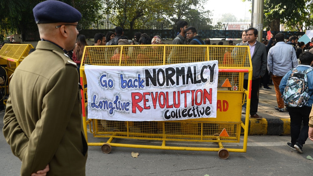 A banner is placed over a Delhi police barricade at a demonstration against India’s new citizenship law and against an attack on students and teachers at the JNU