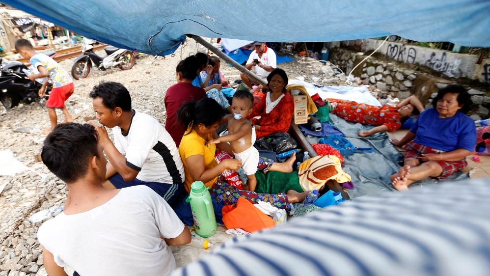 Displaced residents sought shelter at a makeshift tent in capital Jakarta on Friday