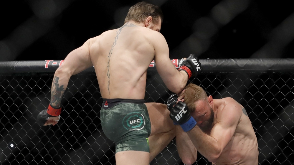 McGregor lands a knee to the face of Cerrone in the first round of the welterweight bout during UFC246