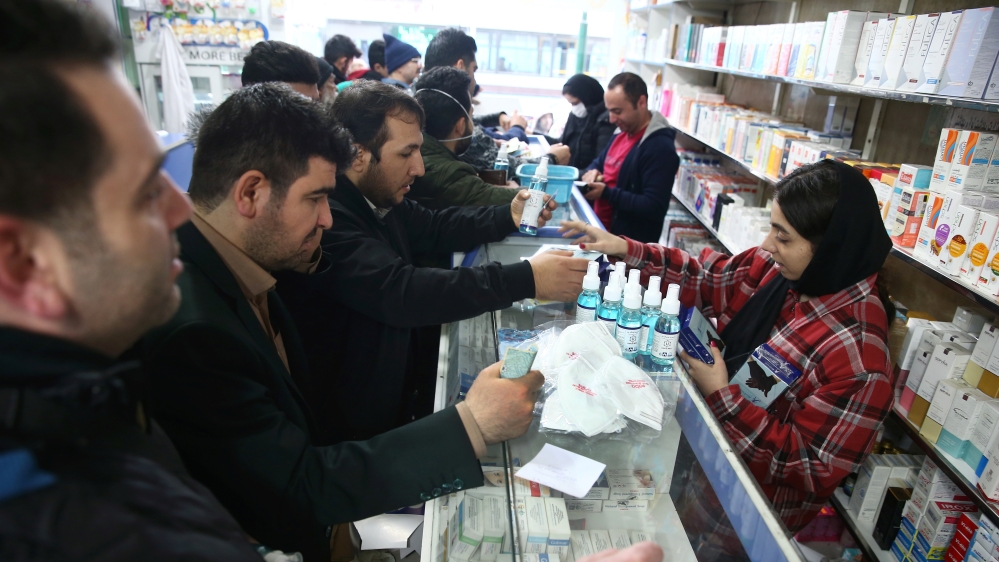 Iranians buy protective masks in a drug store to prevent contracting a coronavirus, in Tehran