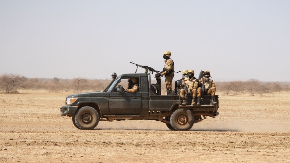 Burkina Faso soldiers patrol aboard a pick-up truck on the road from Dori to the Goudebo refugee camp, on February 3, 2020. OLYMPIA DE MAISMONT / AFP