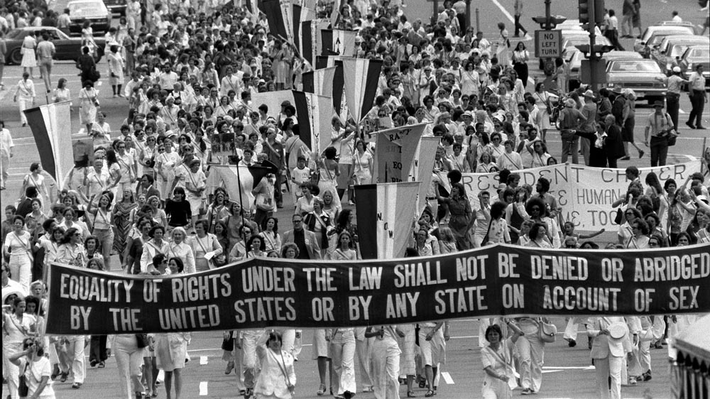 Supporters of the Equal Rights Amendment carry a banner down Pennsylvania Avenue in Washington, DC, on August 26, 1977