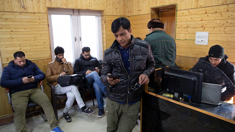 In this Jan. 30, 2020, photo, Kashmiri journalists browse the internet on their mobile phones inside the media center set up by government authorities in Srinagar, Indian controlled Kashmir. Six month