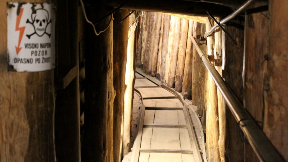 The inside of the tunnel in the direction of Dobrinja, showing a sign that reads ‘High voltage, alert, life-threatening’ [Photo courtesy of Tyra Bosnic]