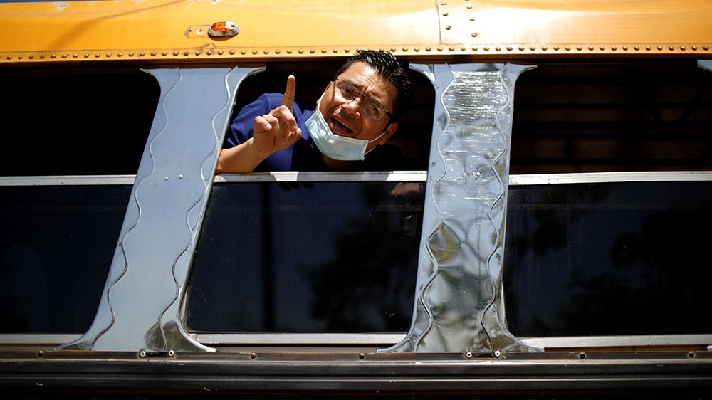 A passenger reacts as he arrives at a facility where travellers are to be quarantined as El Salvador enforces measures due to concerns over coronavirus disease (COVID-19), in Jiquilisco, El Salvador