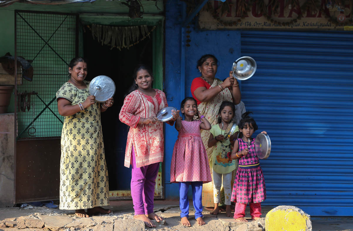 Indians bang utensils outside their home to cheer health workers in Hyderabad, India, Sunday, March 22, 2020. India is Sunday observing a 14-hour "people''s curfew" called by Prime Minister Narendra Mo