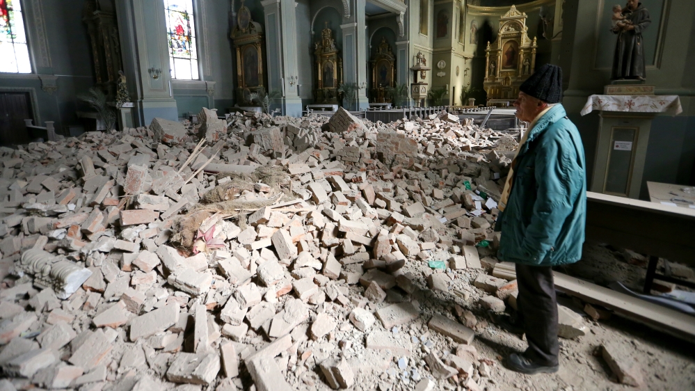 A man looks at damages at the Basilica of the Heart of Jesus, following an earthquake in Zagreb