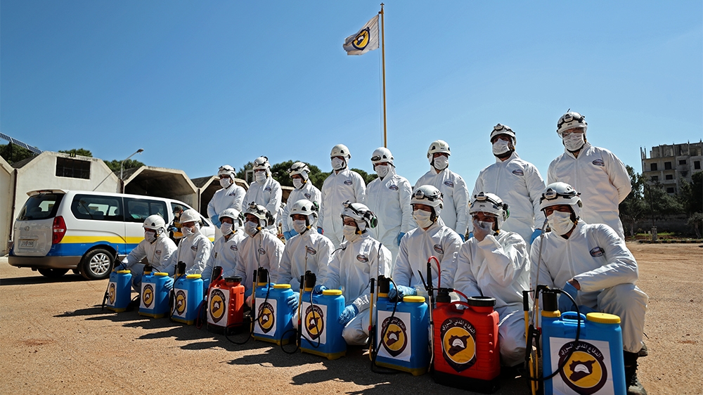 Members of the Syrian Civil Defence prepare their sterilisation equipment before sterilising a hospital in Idlib