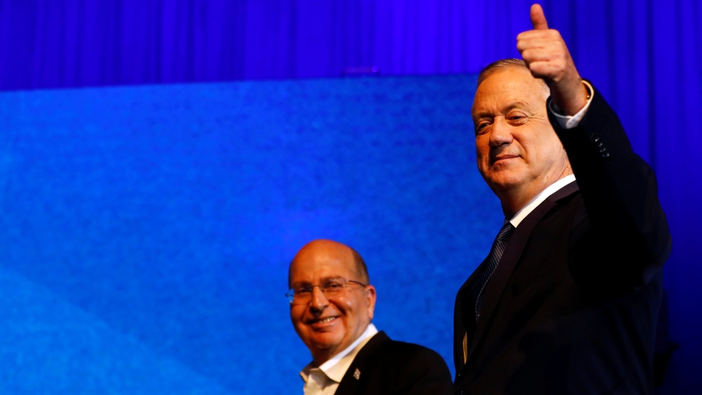 Blue and White party leader Benny Gantz gestures as he stands next to his party co-leader Moshe Yaalon