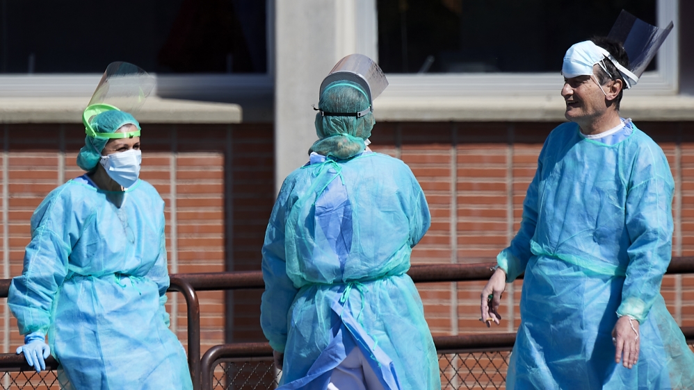 Health personnel are seen outside the emergency entrance of the Severo Ochoa Hospital in Madrid, Spain Carlos Alvarez/Getty Images]