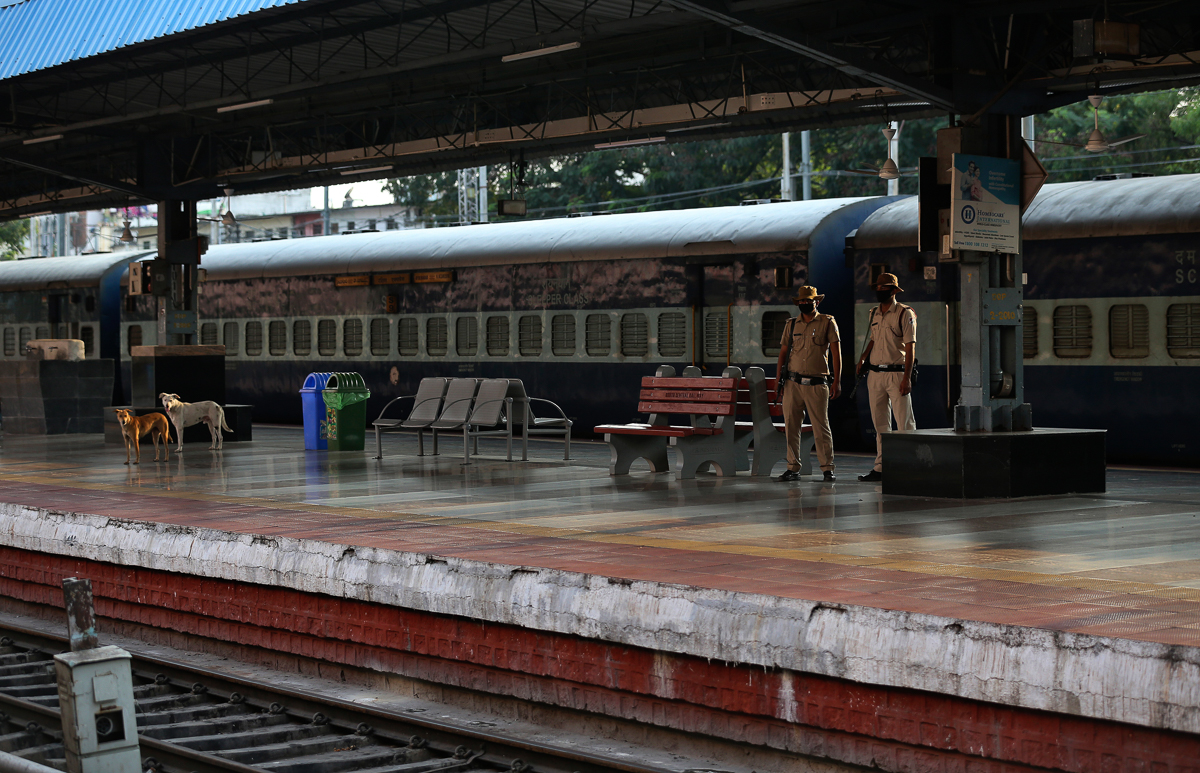 Indian Railway Protection Force personnel wearing face masks patrol at Hyderabad railway station during a lockdown as a precautionary measure against COVID-19 in Hyderabad, India, Monday, March 23, 20