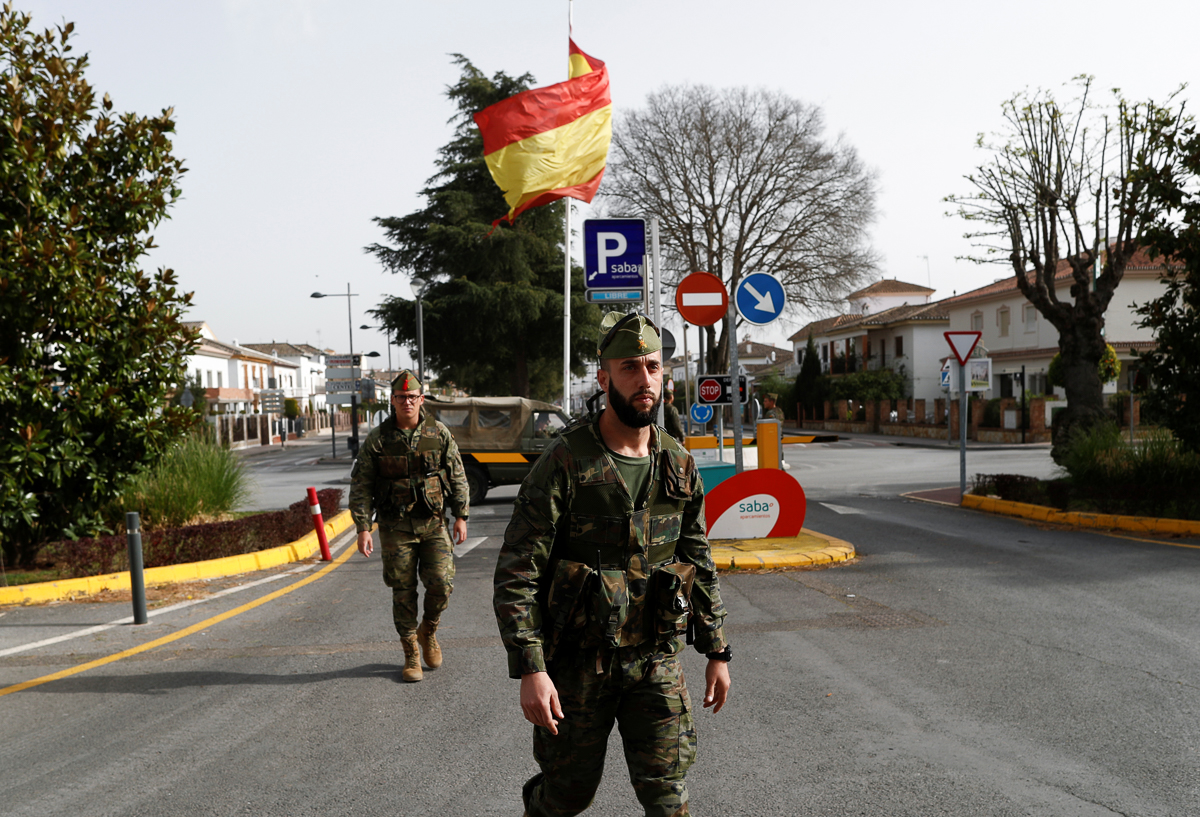 Spanish legionnaires patrol an empty train station during partial lockdown as part of a 15-day state of emergency to combat the coronavirus disease (COVID-19) outbreak in downtown Ronda, southern Spai