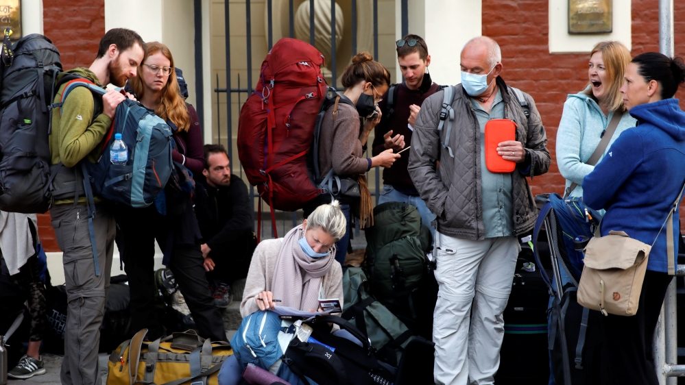 Stranded tourists from Germany wait for a shuttle bus to transport them to the airport in Kathmandu