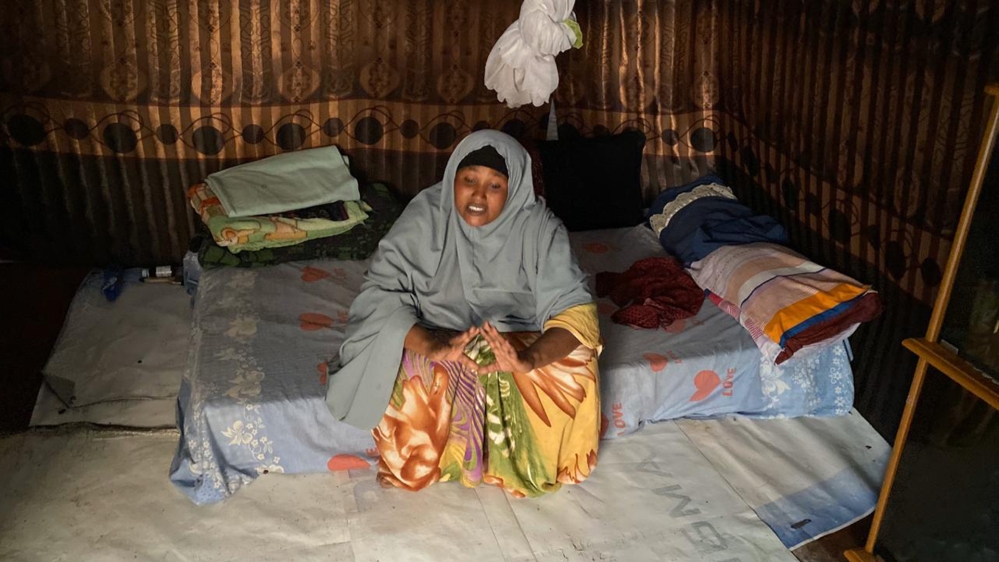 Amina Duba sits in her home in Korogocho
