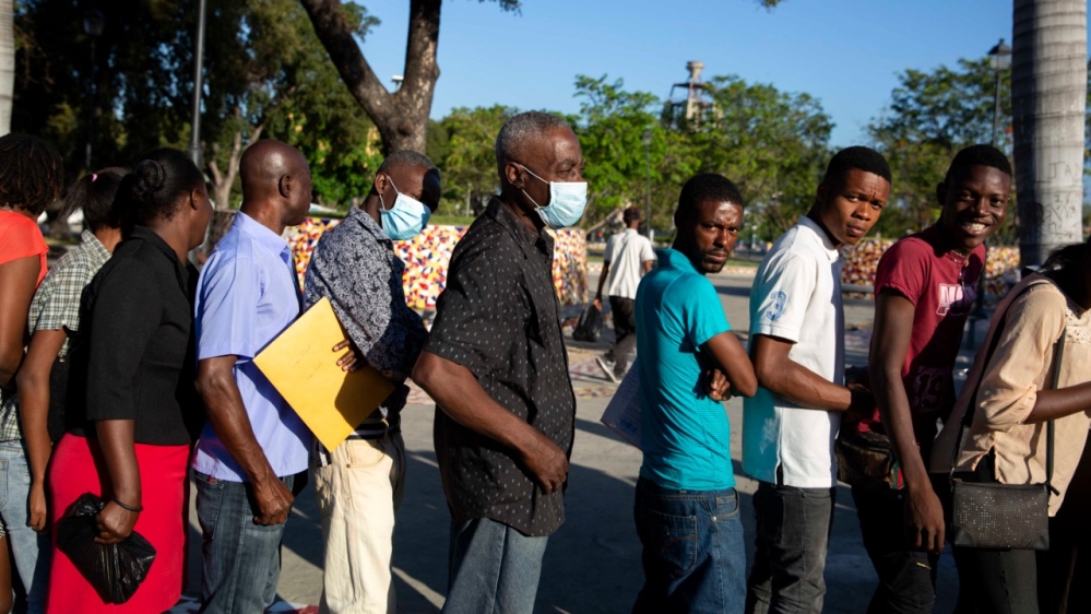 People line up for national identification cards at a government office before it potentially closes amid measures to contain the spread of the new coronavirus in Port-au-Prince, Haiti on March 24.
