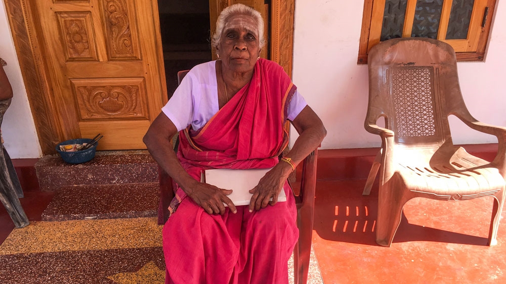 Chellamma Singharatnam sits outside her home in northern Sri Lanka that was taken by the army during the decades-long war, returned to her after she staged a hunger strike
