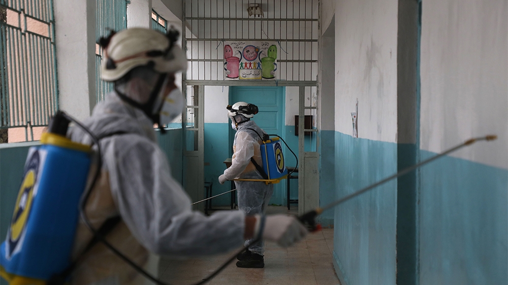 Members of the Syrian Civil Defence, also known as the White Helmets, sterilise a school in the area of Ghosn al-Zeitun in Afrin