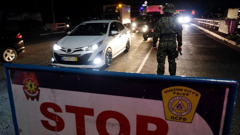 A checkpoint is set up in Quezon City, part of Metro Manila, Philippines early in March as police, backed by the army and coast guard, started sealing off the densely-populated capital from the rest of the country.