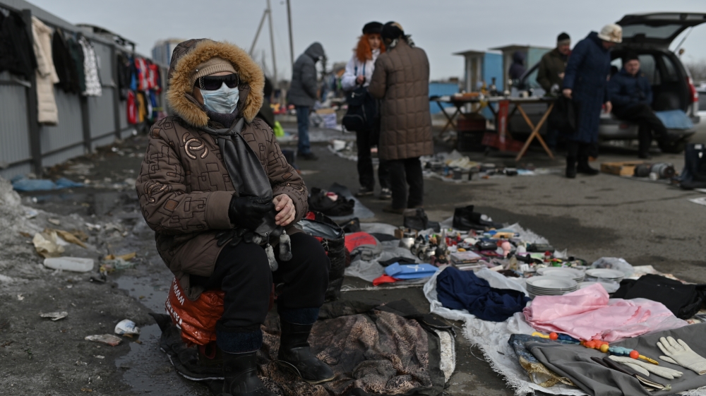 A vendor wearing a protective face mask waits for customers at a local flea market, as the spread of the coronavirus disease continues, in Omsk, Russia
