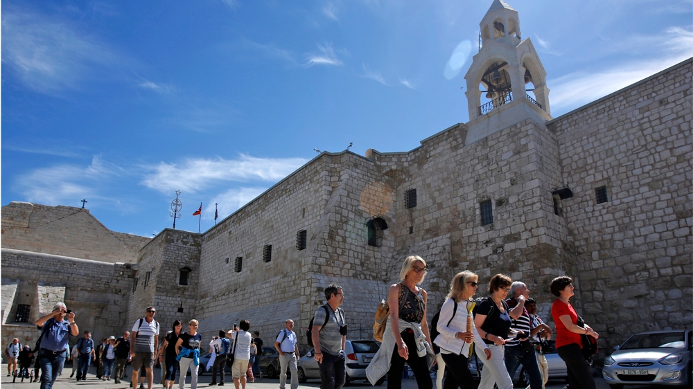Foreign tourists visit the Church of the Nativity, revered as the birthplace of Jesus Christ, in the West Bank city of Bethlehem on March 05, 2020.