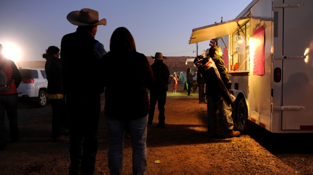 People wait for food from a mobile vendor at the Utah Navajo Fair in Bluff, Utah