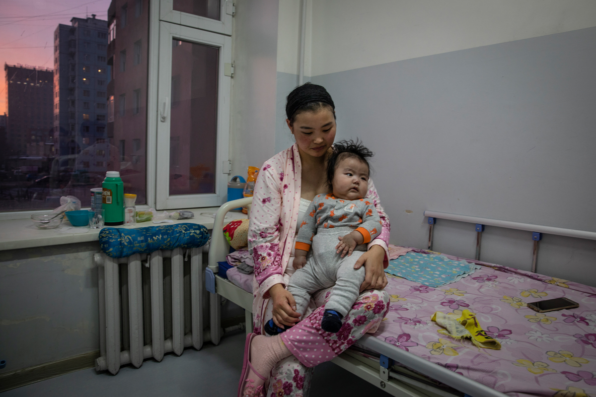 A mother holds her baby boy who has been suffering from pneumonia in a paediatric unit in one of the city hospitals in the capital Ulaanbaatar, January 15, 2019. An ever-increasing number of children