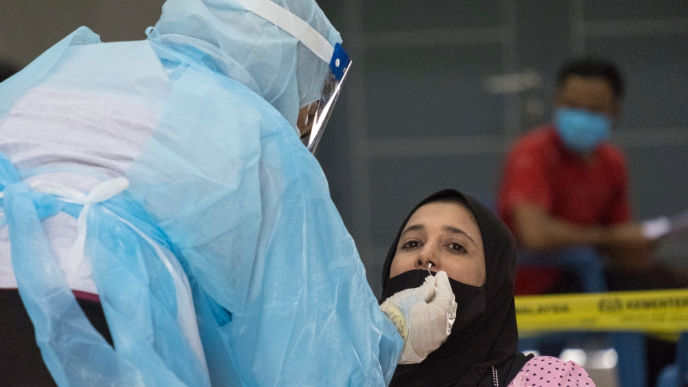 A woman is tested for Covid-19 at a temporary testing facility set up by the Malaysian Ministry of Health in a community centre at the outskirts of Kuala Lumpur. The Ministry of Health has provided fr
