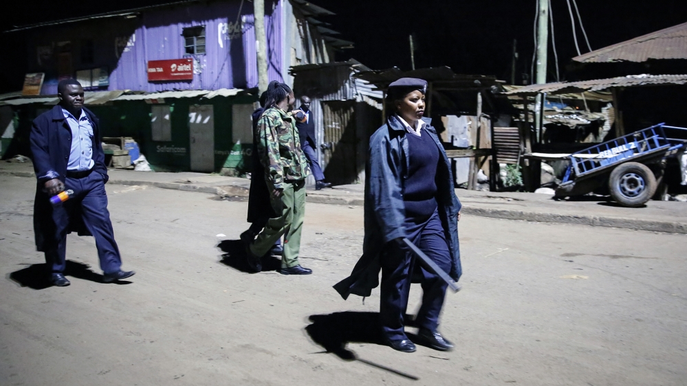 Kenyan police carrying batons and teargas patrol looking for people out after curfew in the Kibera slum, or informal settlement, of Nairobi, Kenya Sunday, March 29, 2020. The curfew which runs from 7p
