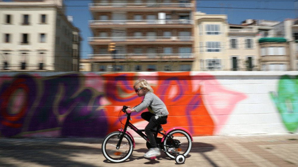 A child rides her bicycle along a pathway, after restrictions were partially lifted for children for the first time in six weeks, following the coronavirus disease (COVID-19) outbreak in