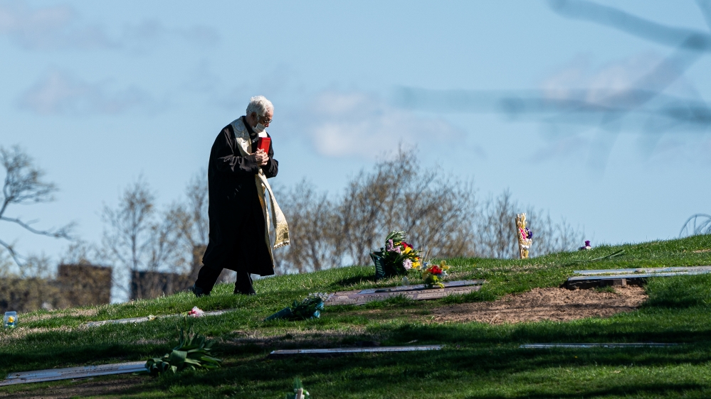 A pastor wearing a protective mask is seen at The Green-Wood Cemetery during the outbreak of the coronavirus disease (COVID-19) in the Brooklyn borough of New York City