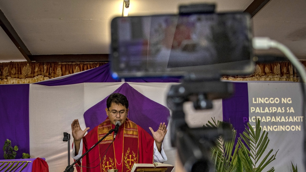 A Catholic priest holds Palm Sunday services over an internet livestream in Quezon city, Metro Manila