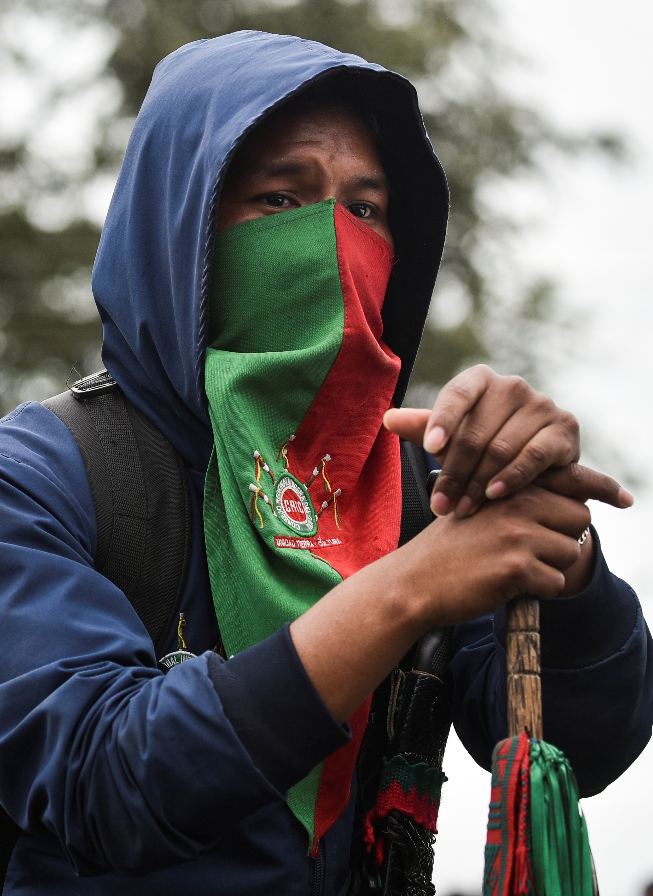 A man of the Nasa Indigenous group stands guard in Corinto, Cauca department, Colombia [Luis Robayo/AFP]