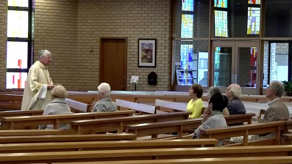 Father Geoffrey Plant presides the Sunday service attended by only 10 people in New South Wales [Reuters]