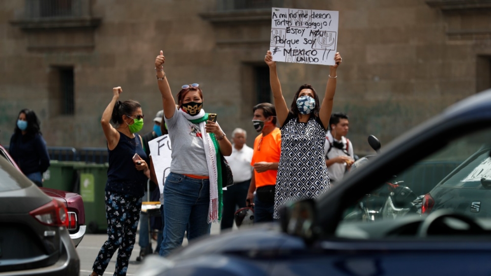 A small group of protesters rally on Saturday against Mexican President Andres Manuel Lopez Obrador and his handling of the coronavirus pandemic